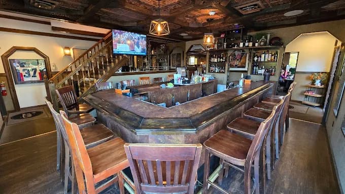 The wraparound bar at The Mansard, with bottles backlit along the back wall