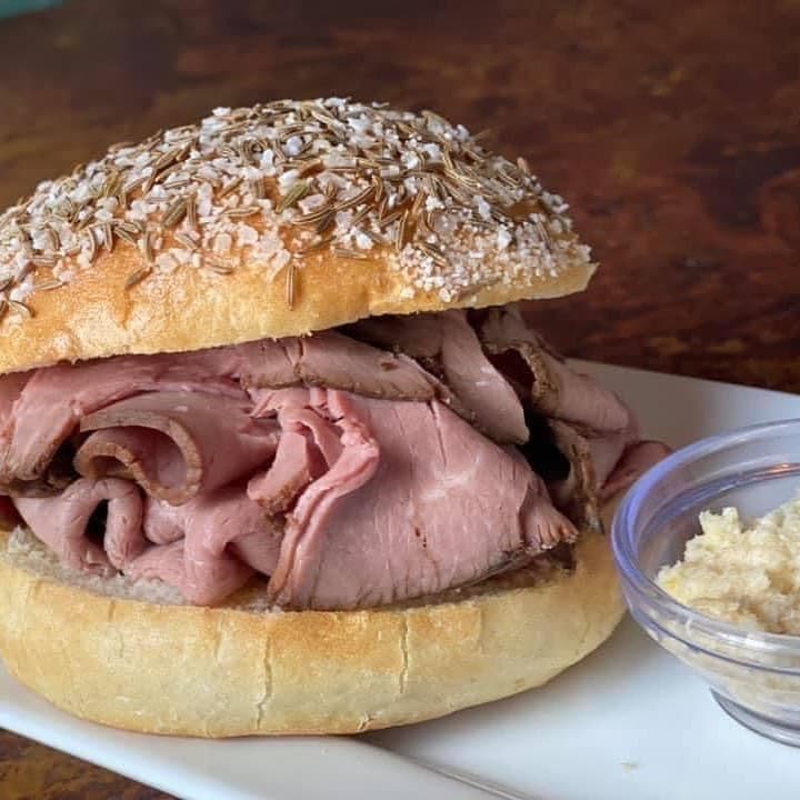 The Mansard beef on weck — slow-roasted rare beef on a kummelweck roll with caraway seeds and rock salt, served with horseradish